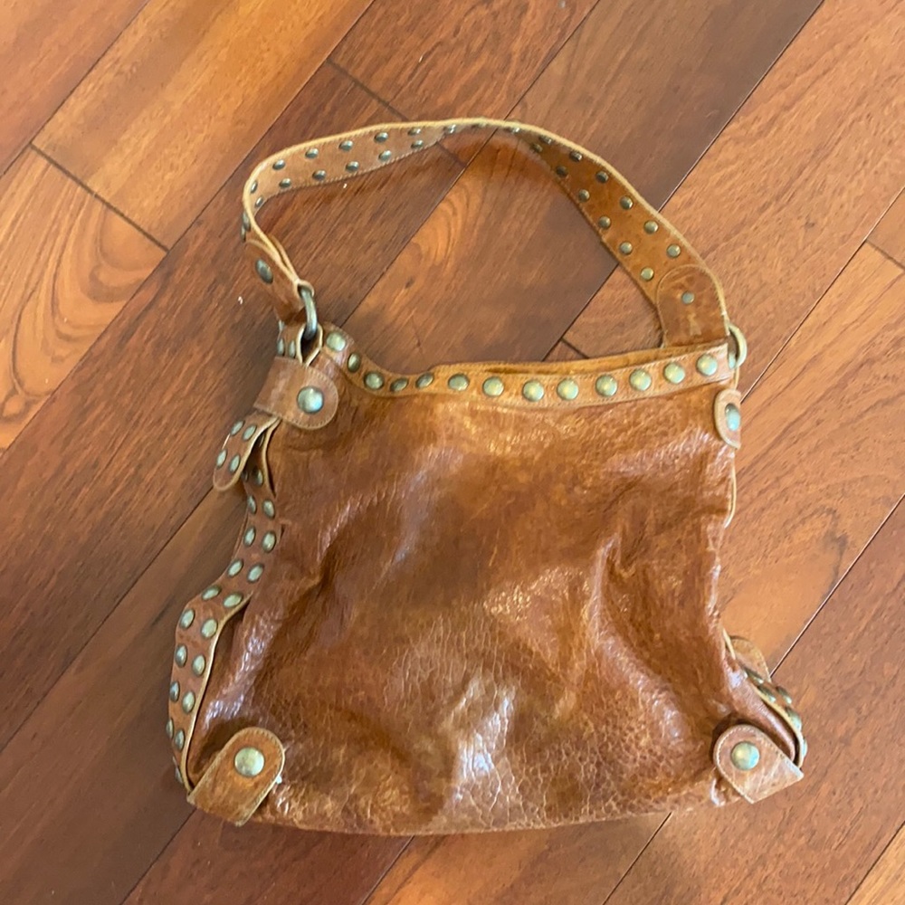Authentic leather soft tan color hand bag w nail trim.